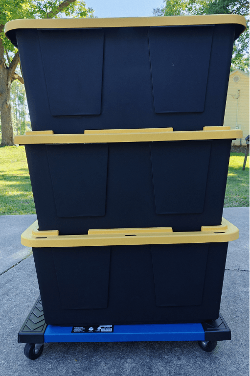 Three of Tina's moving totes stacked neatly on a rolling dolly, ready to move
